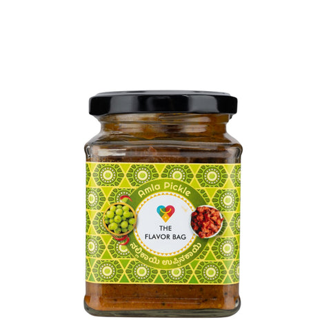 The Flavor Bag Amla Pickle in a glass jar with a black lid, featuring a vibrant green label with traditional Indian patterns and images of gooseberries and pickle.