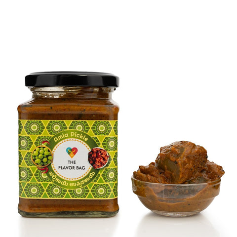 The Flavor Bag Amla Pickle in a glass jar with a small bowl of pickle. Traditional South Indian recipe.
