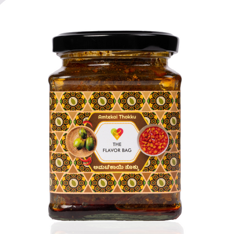 The Flavor Bag Amtekai Thokku in a glass jar with a patterned label featuring hog plum and chutney illustrations.