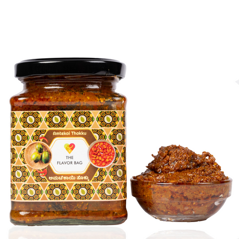The Flavor Bag Amtekai Thokku chutney in a glass jar with a small bowl of the spicy South Indian pickle beside it.