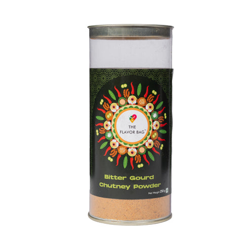 The Flavor Bag Bitter Gourd Chutney Powder in a clear cylindrical container with a decorative spice-themed label.