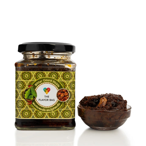 The Flavor Bag Bitter Gourd Pickle in a glass jar with a small bowl of pickle. Authentic South Indian recipe.