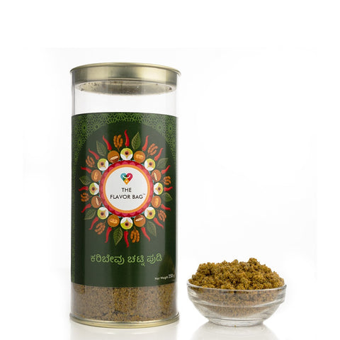The Flavor Bag Curry Leaf Chutney Powder in a tall green canister with a circular spice motif. A small bowl of the powder is beside it.