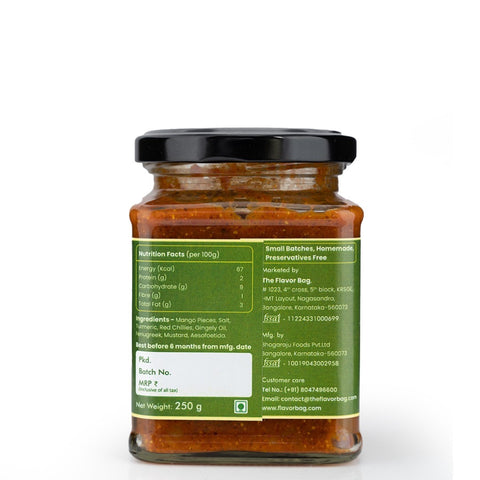 The Flavor Bag Cut Mango Pickle in a glass jar, made with mango pieces, salt, turmeric, red chilies, gingelly oil, fenugreek, mustard, and asafoetida.
