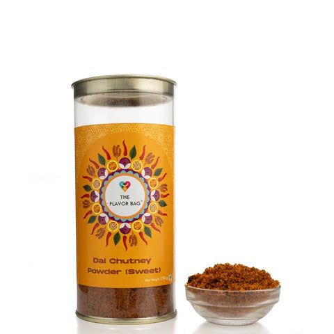 The Flavor Bag Dal Chutney Powder (Sweet) in a clear jar with a small bowl of powder. Made with roasted lentils and spices.