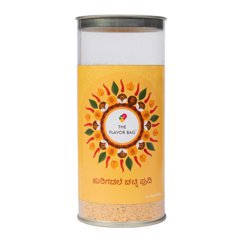 The Flavor Bag Fried Gram Chutney Powder in a clear cylindrical container with a yellow label and floral design.