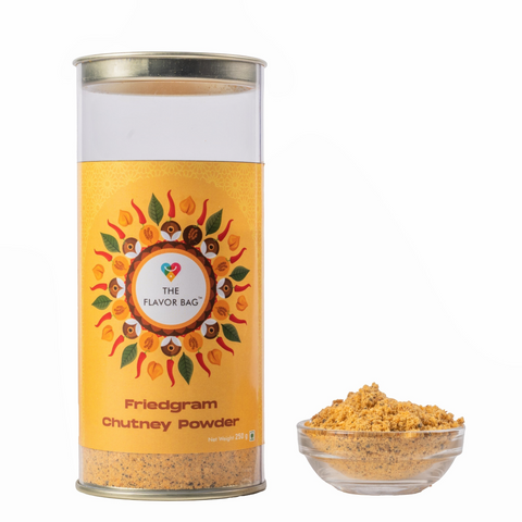 The Flavor Bag Fried Gram Chutney Powder in a clear cylindrical container with a yellow label and a small glass bowl.