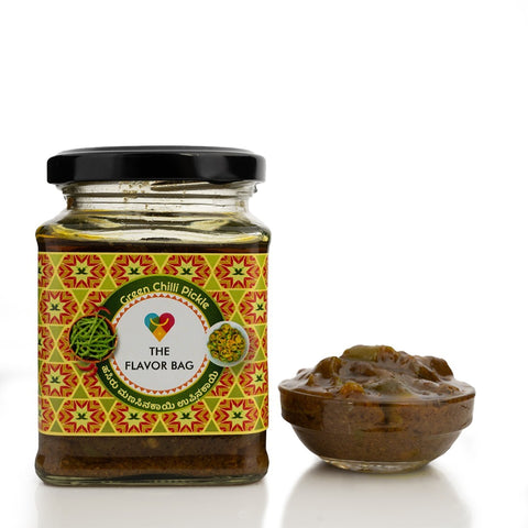 The Flavor Bag Green Chilli Pickle in a glass jar with a small bowl of pickle. Traditional South Indian recipe.