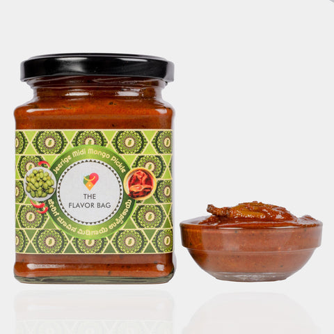 The Flavor Bag Jeerige Midi Pickle in a glass jar next to a small bowl of spicy South Indian mango pickle