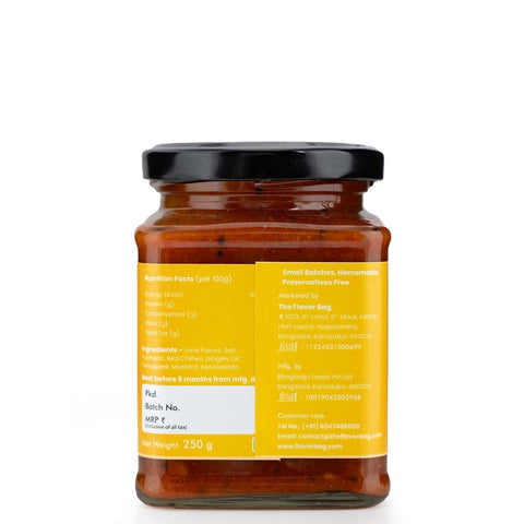 The Flavor Bag Lime Pickle in a glass jar, featuring a bold orange-red color with visible lime pieces and spices. Authentic South Indian recipe.