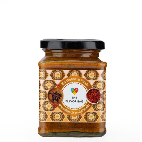 The Flavor Bag Makali Beru Pickle, a traditional South Indian pickle in a glass jar with a black lid. The label features a decorative pattern and text in Kannada.