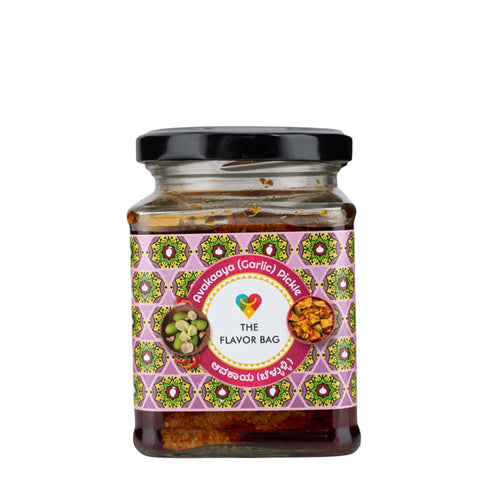 The Flavor Bag Mango Avakai (Garlic) Pickle in a glass jar with a decorative label featuring mango pieces and garlic.