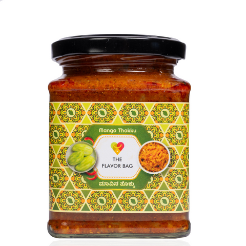 The Flavor Bag Mango Thokku in a glass jar with a decorative label featuring traditional South Indian patterns.