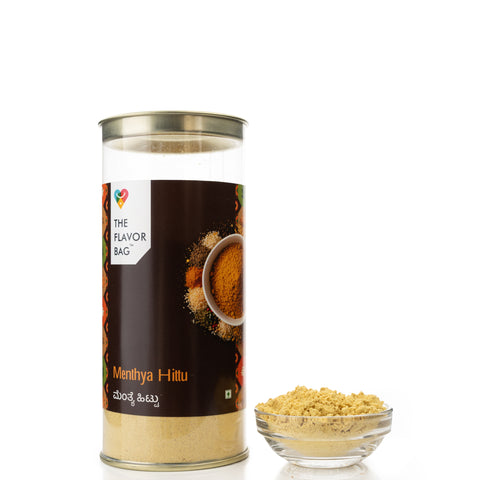 The Flavor Bag Menthya Hittu, a South Indian chutney powder made with roasted lentils and spices, presented in a clear container with a decorative label.