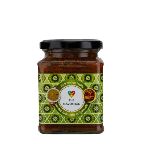 The Flavor Bag Midi Mango Pickle in a glass jar with a black lid. Traditional South Indian pickle.