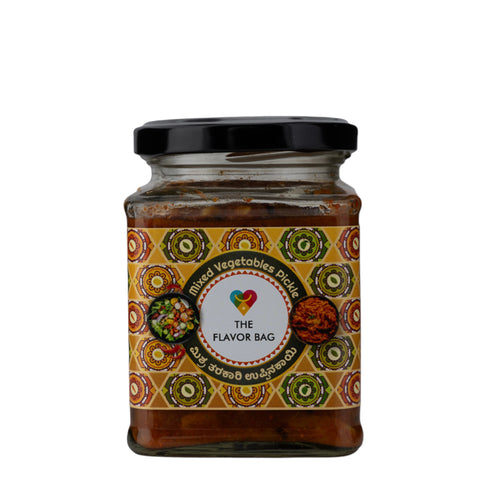 The Flavor Bag Mixed Vegetable Pickle in a glass jar with a black lid. Traditional South Indian pickle with a bold, balanced flavour.