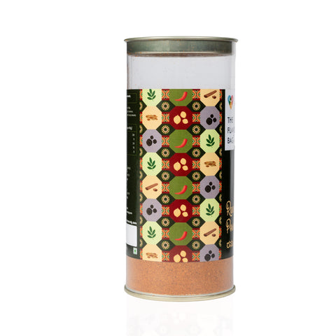 The Flavor Bag Rasam Powder in a clear cylindrical container with a colorful spice-patterned label.