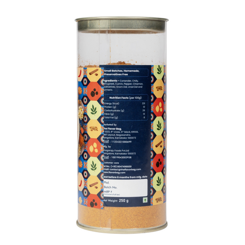 The Flavor Bag Sambar Powder in a clear cylindrical container showing ingredients and nutrition facts label