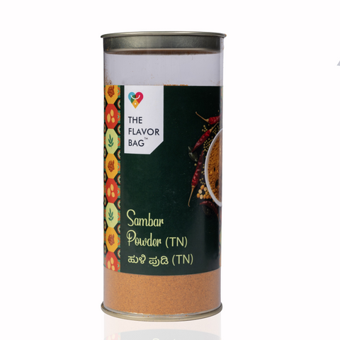 The Flavor Bag Tamil Nadu style Sambar Powder in a clear cylindrical spice container with a dark green label.