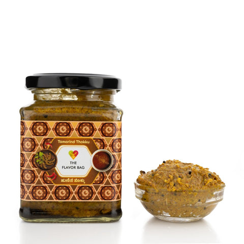 The Flavor Bag Tamarind Thokku, a thick South Indian chutney in a glass jar and bowl, perfect for rice, dosa, idli, and chapati.
