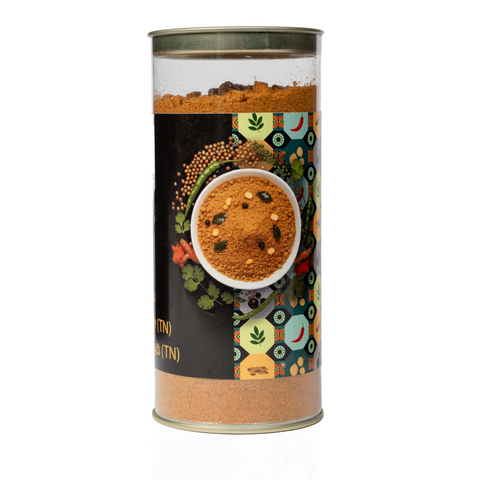 The Flavor Bag TN Style Rasam Powder in a clear cylindrical container with a decorative spice-themed label.