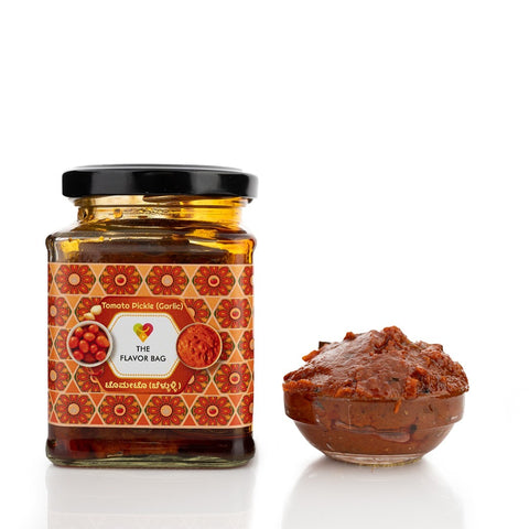 The Flavor Bag Tomato Chutney (Garlic) in a glass jar with a small bowl of chutney. Traditional South Indian style.