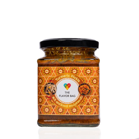 The Flavor Bag Turmeric Pickle in a glass jar with a patterned orange label featuring traditional Indian motifs.