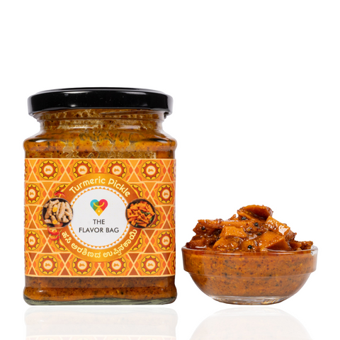 The Flavor Bag Turmeric Pickle in a glass jar with a small bowl of spicy yellow turmeric pieces on the side