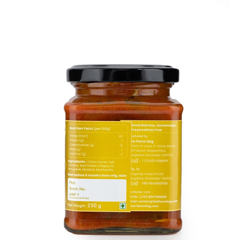 The Flavor Bag Citron Pickle in a glass jar, featuring a vibrant orange-yellow hue and visible citron pieces. Traditional South Indian recipe.